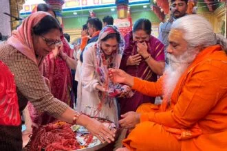 महिला श्रधालुओं को धागा वितरित करते हुए महंत शंकरपुरी